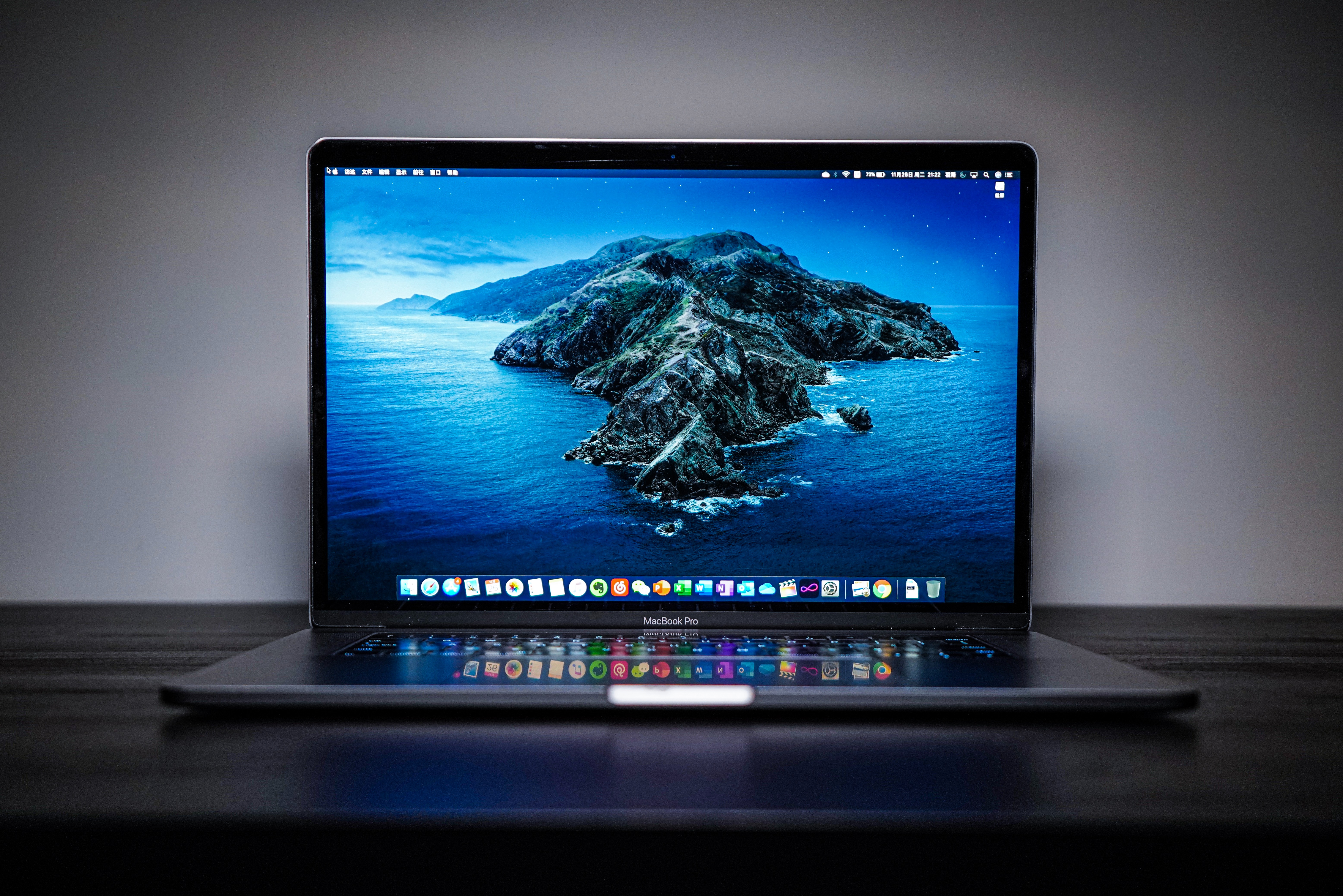 Mac Laptop, with background image of the sea and mountains